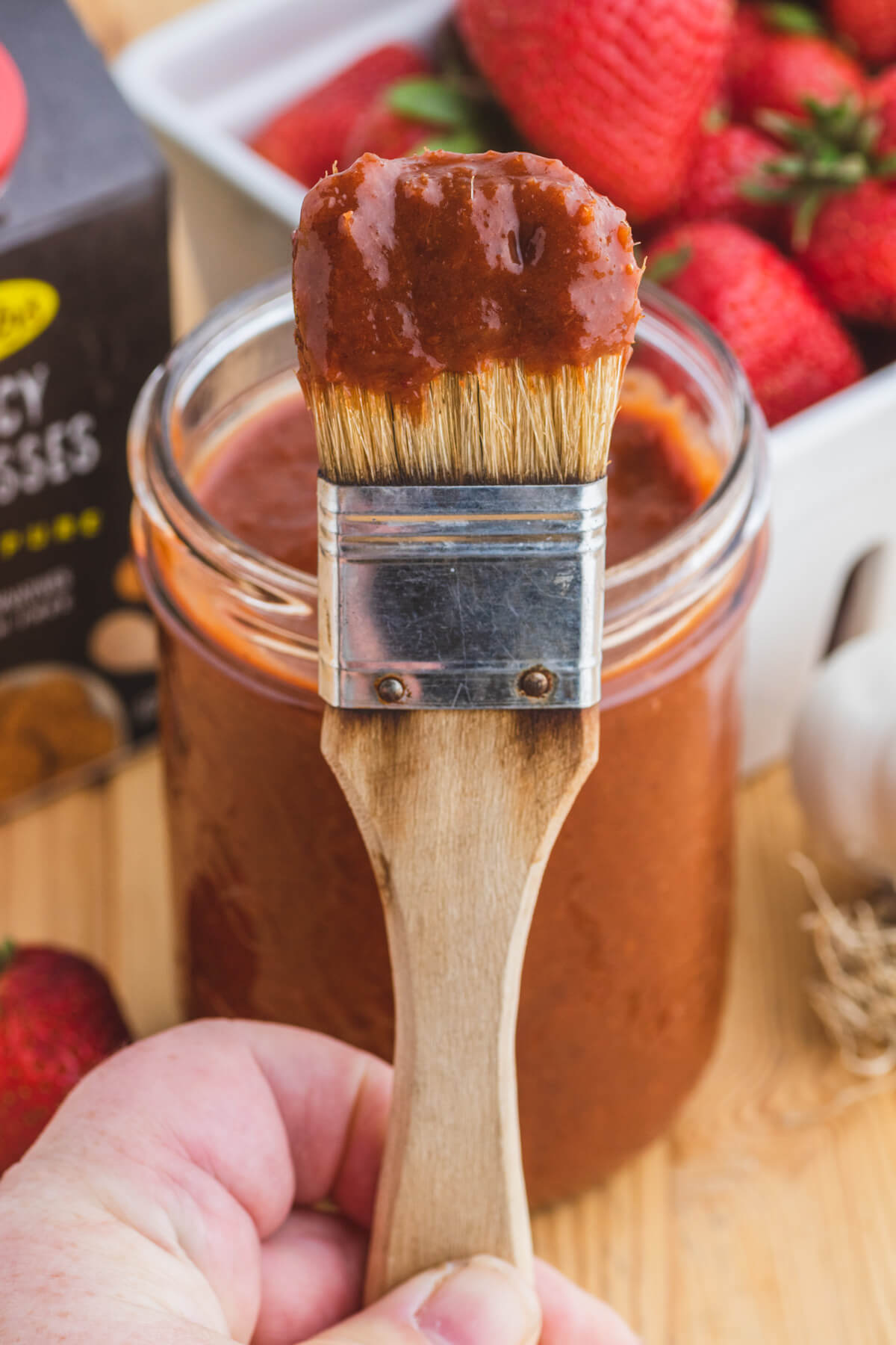 A brush coated in homemade barbecue sauce.
