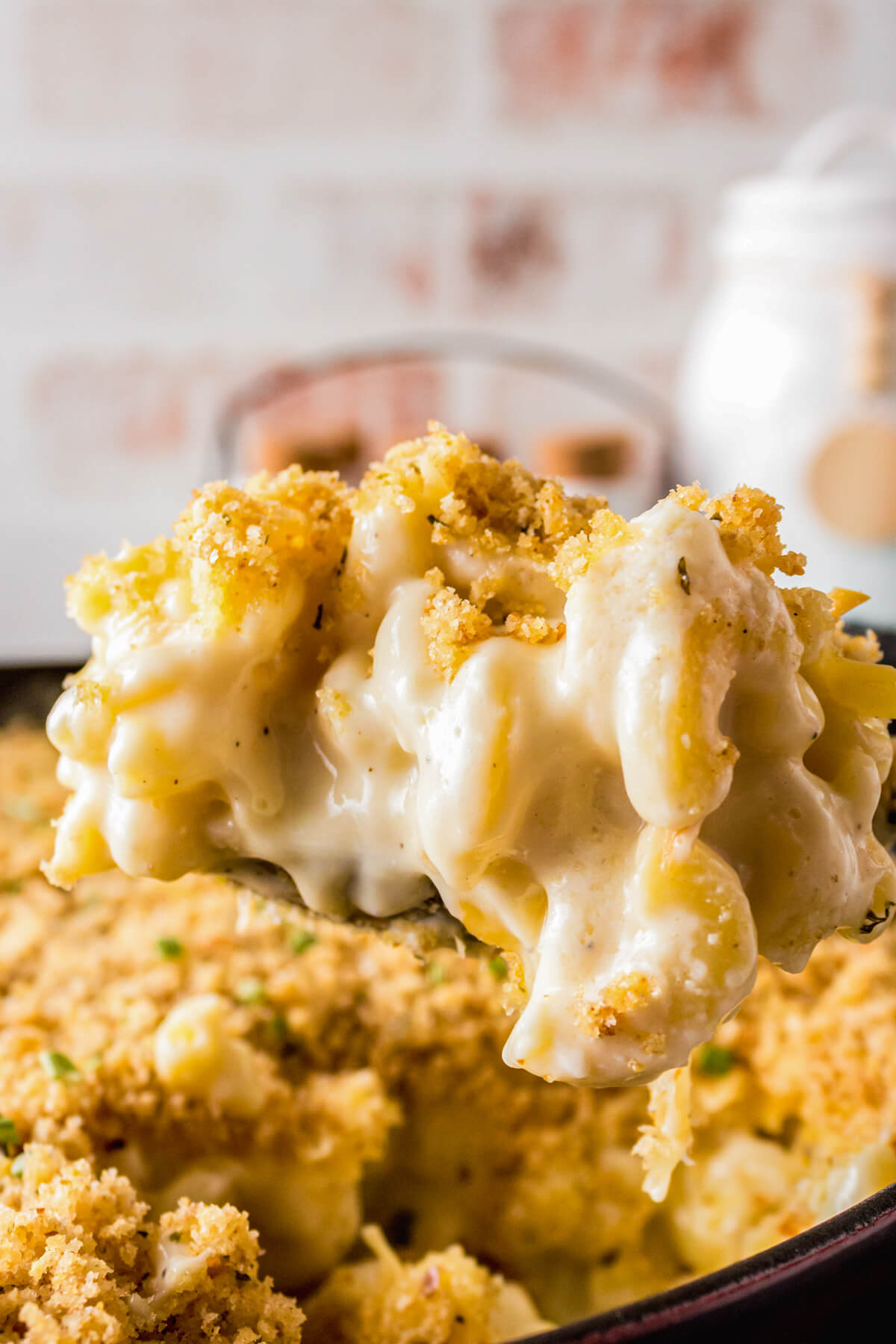 A scoopful of creamy Smoked Mac and Cheese topped with toasted golden bread crumbs.