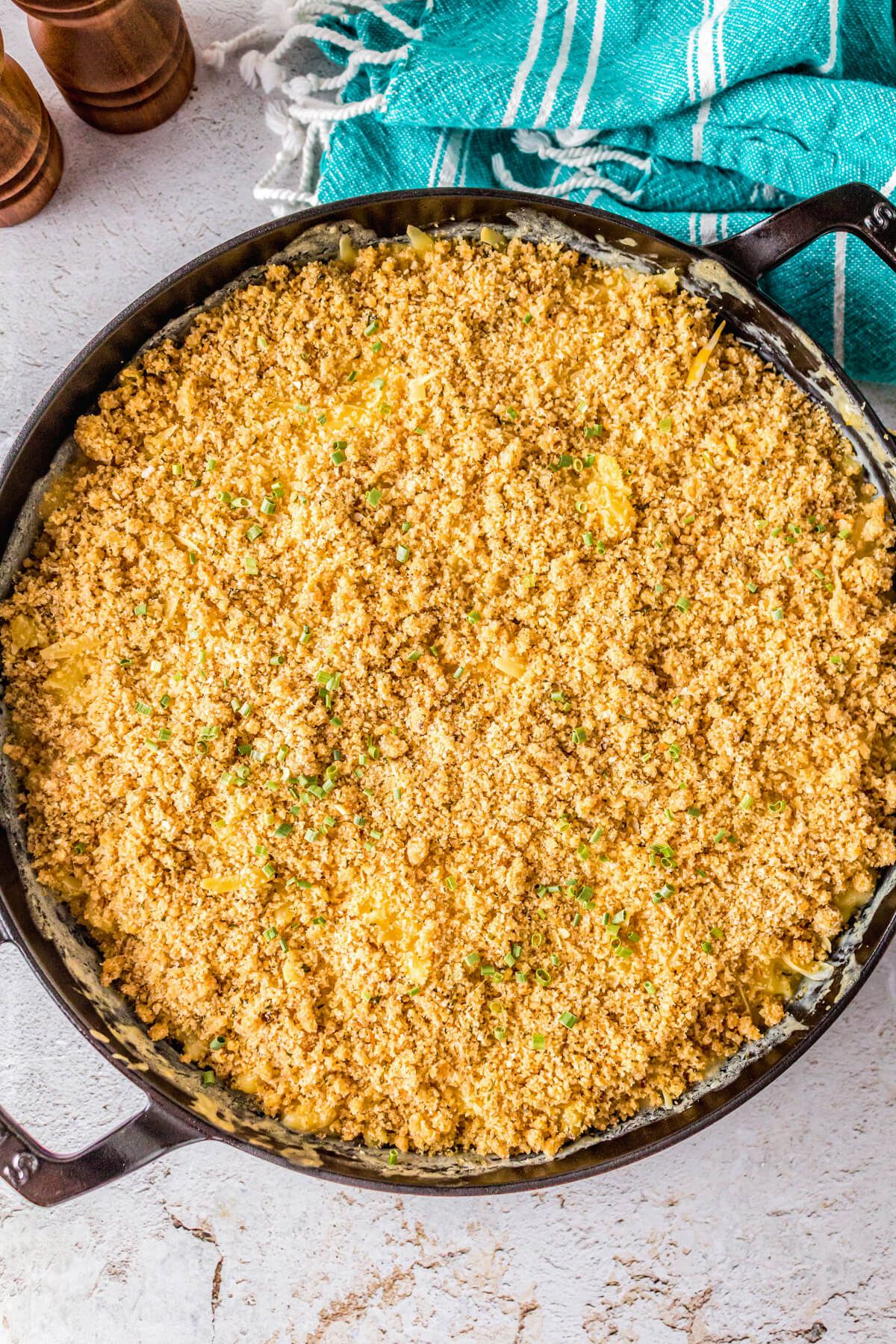 A black cast iron pan full of creamy Smoked Mac and Cheese topped with toasted golden bread crumbs.