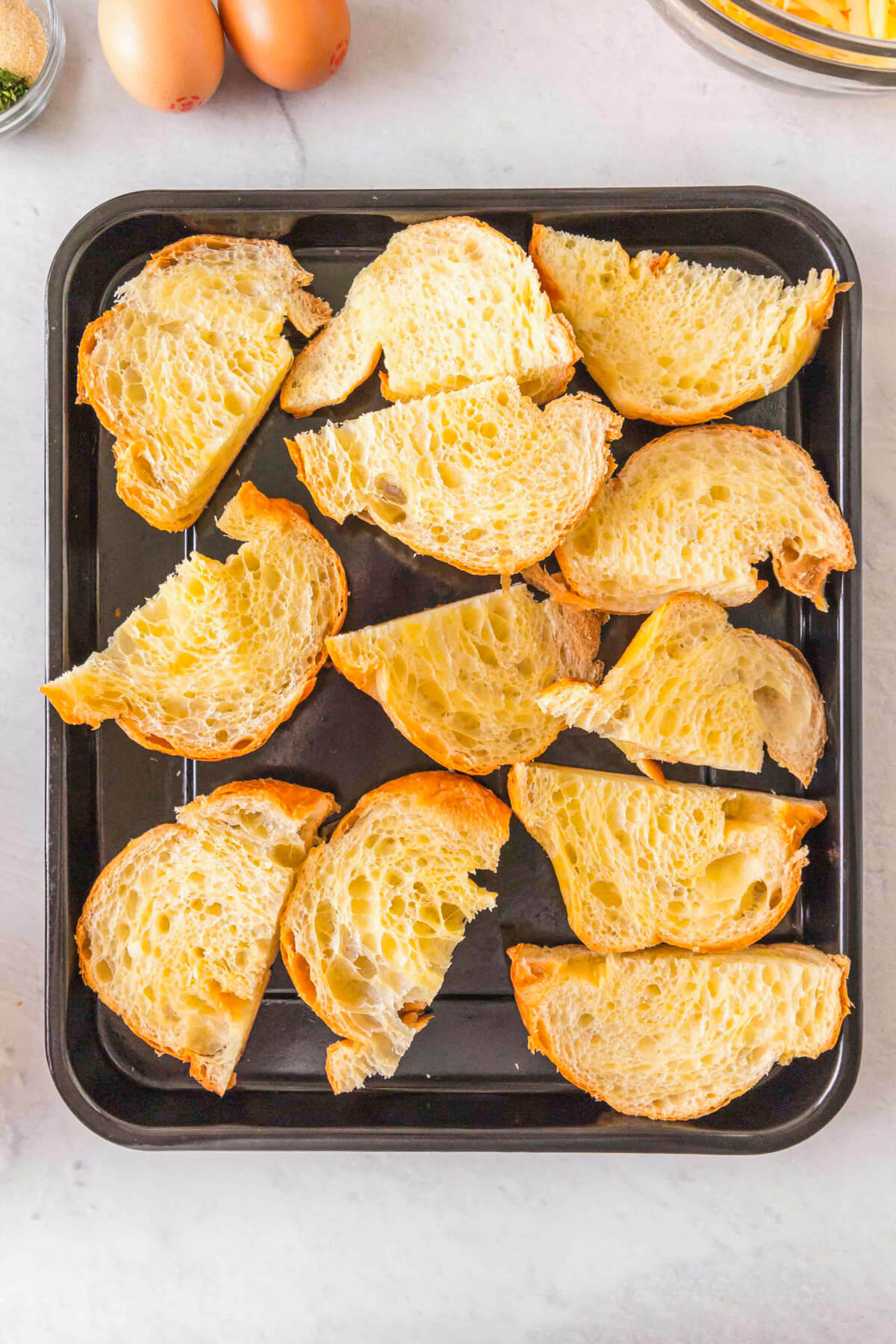 Sliced croissants on a baking sheet.