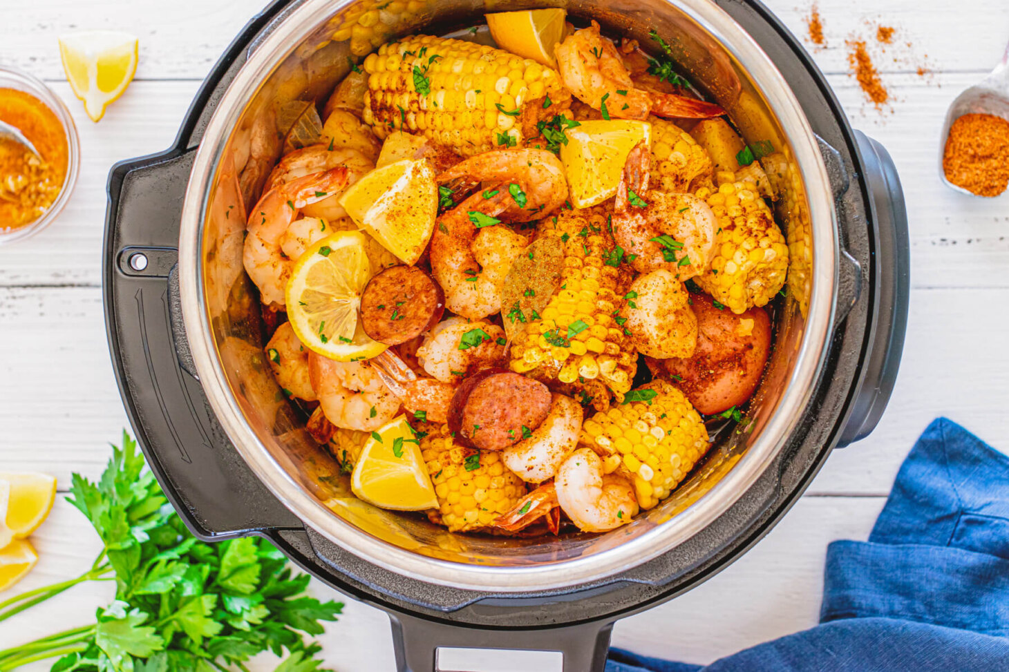 Cooked shrimp boil - Spice coated shrimp, potatoes, and corn in an Instant Pot.