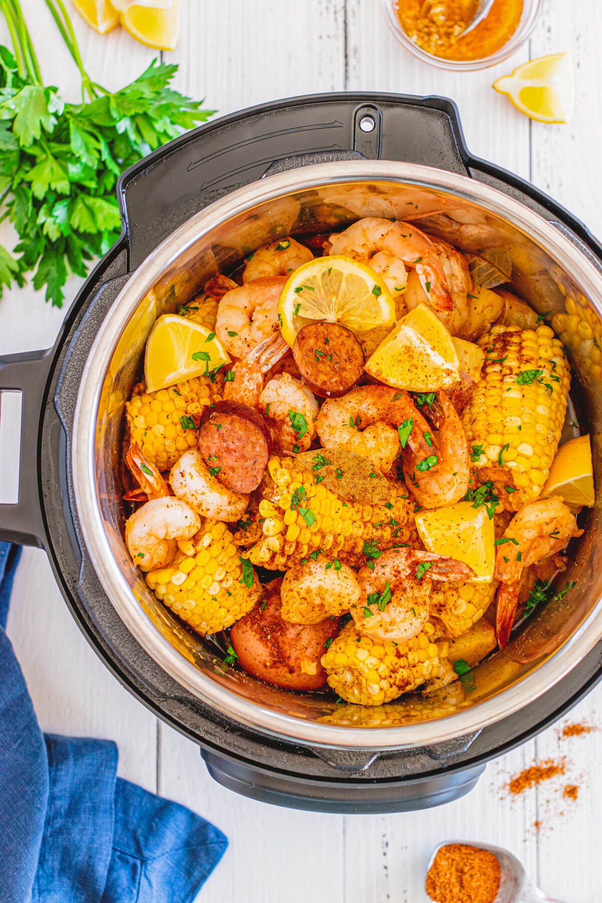 Cooked shrimp boil - Spice coated shrimp, potatoes, sausage, and corn in an Instant Pot.