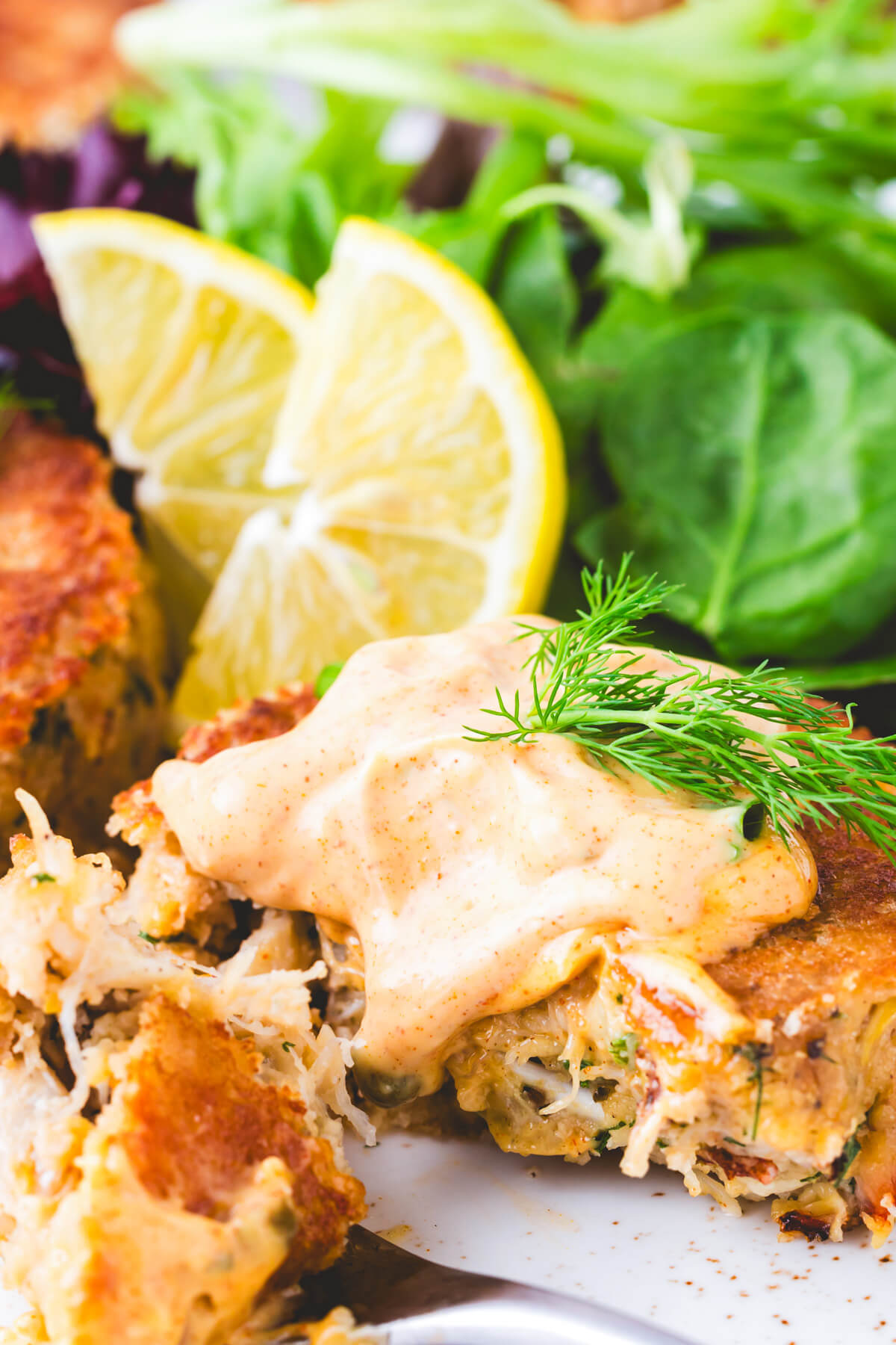 Crab Cakes topped with Cajun aioli served with lemon wedges and fresh greens.
