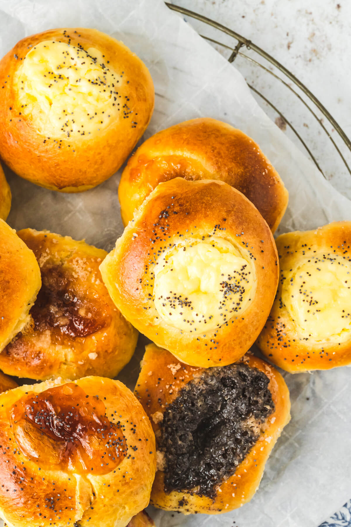 A platter of golden baked kolaches filled with a variety of fillings.