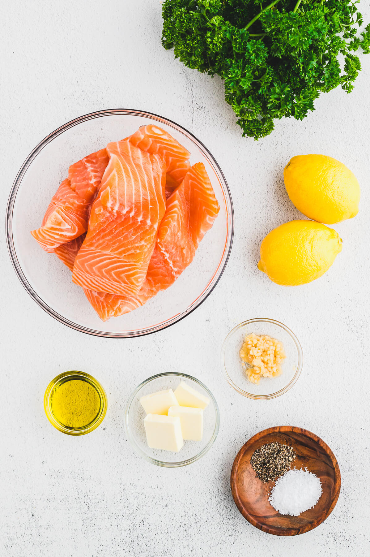 Ingredients required to make baked lemon pepper salmon.
