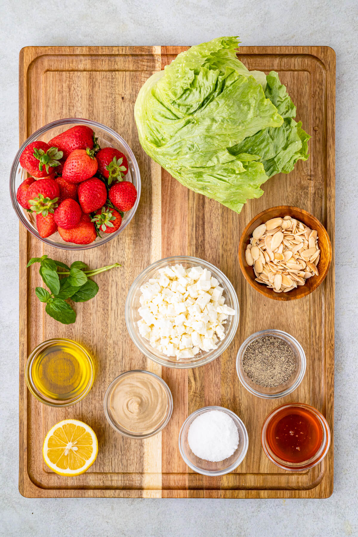 Ingredients required to make a Strawberry Feta Wedge Salad with lemon vinaigrette. 
