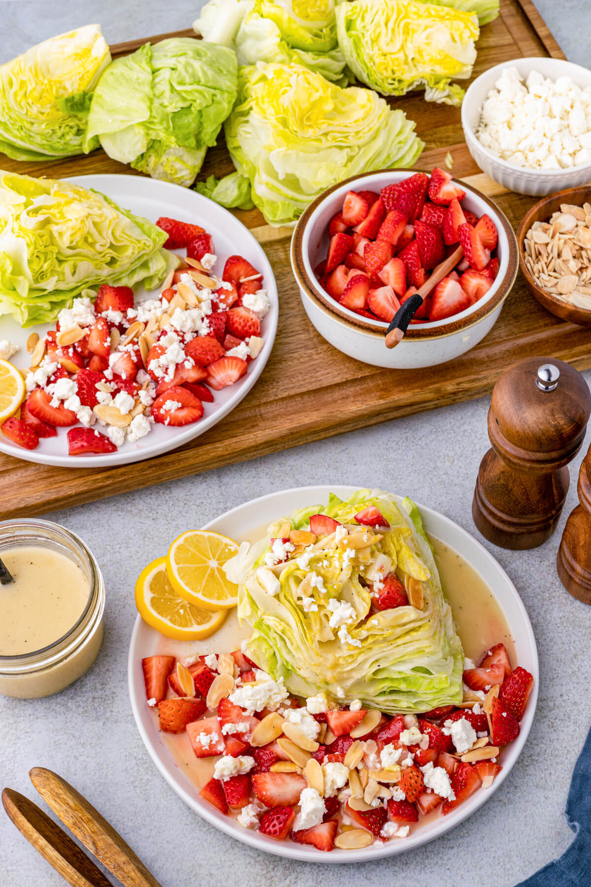 A Strawberry Feta Wedge Salad on white plate in front of a salad serving board.