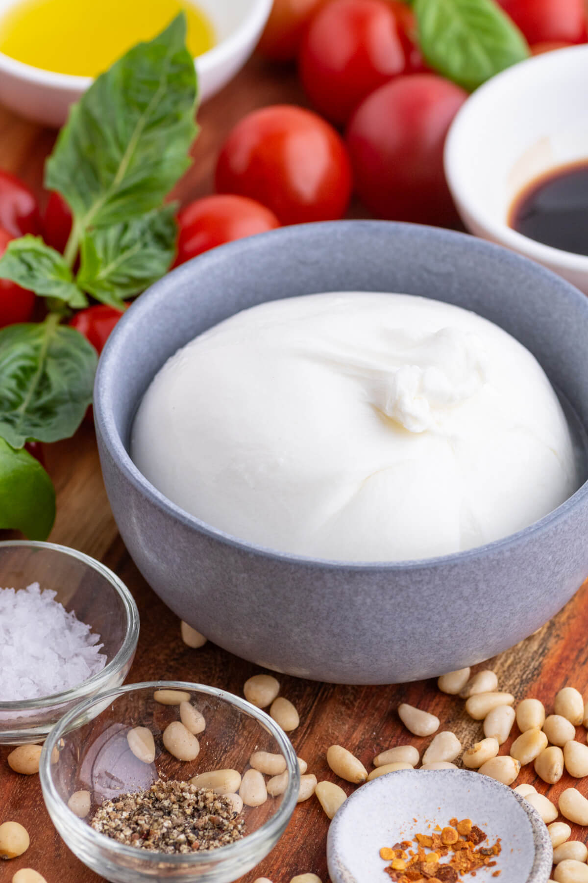 Ingredients required to make Tomato Burrata Salad with pine nuts.