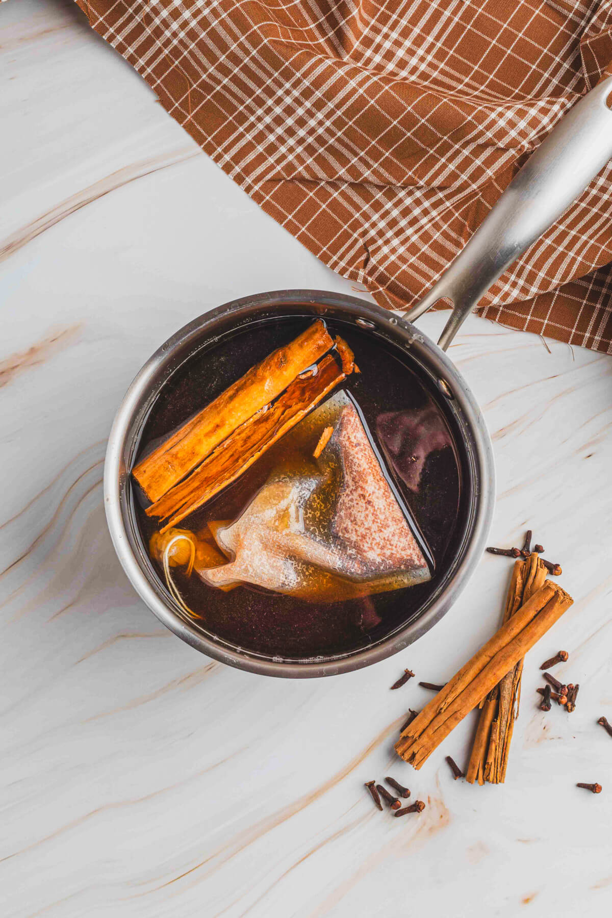 The ingredients for spiced simple syrup in a small saucepan.