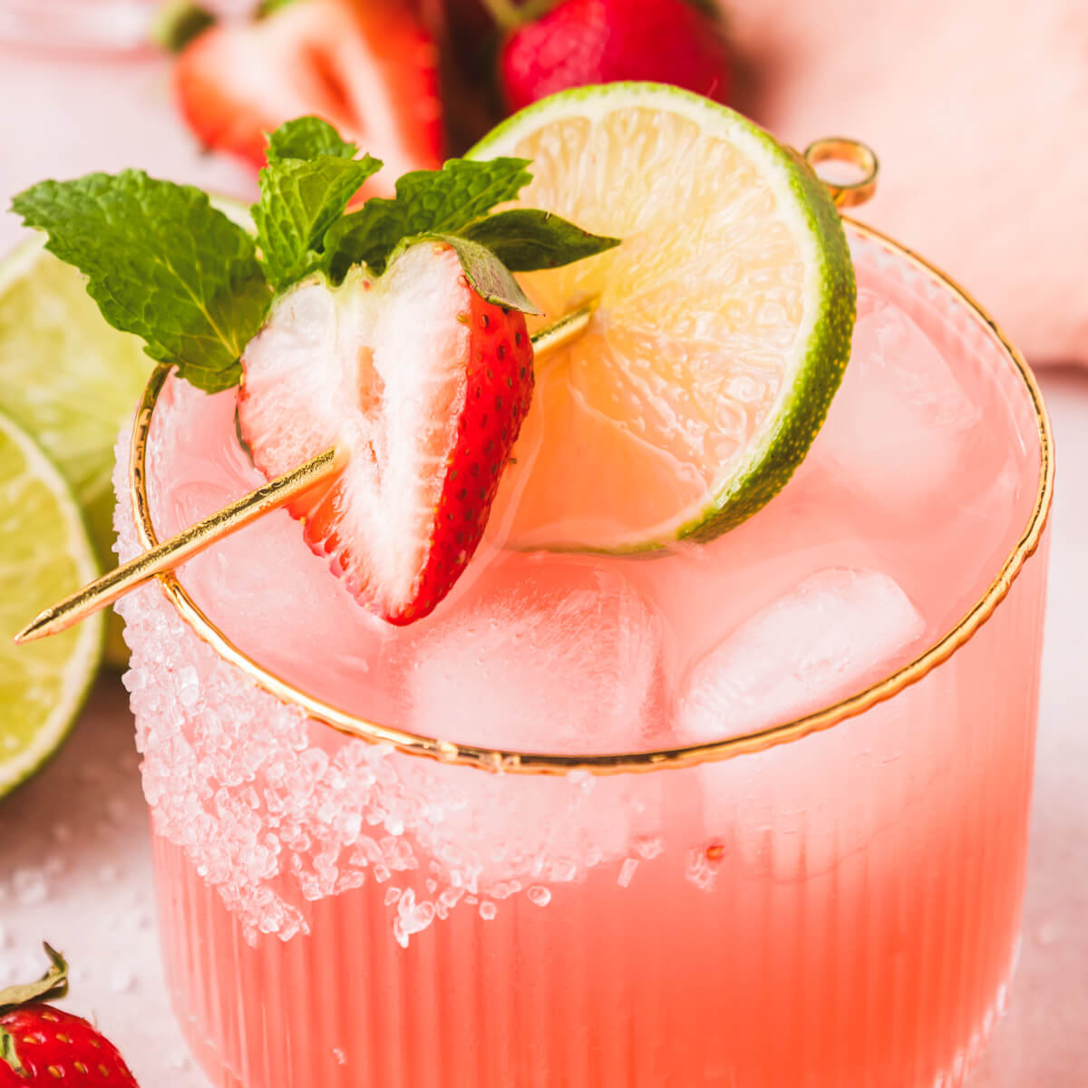 A close up photo showing the garnish and sugar rimmer in a strawberry margarita.