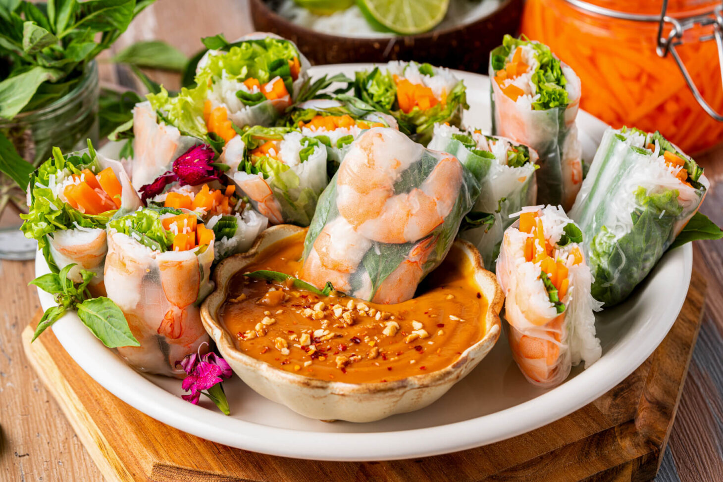 A platter of vibrant Vietnamese Shrimp Salad rolls sliced in half showing bright vegetables and noodles.
