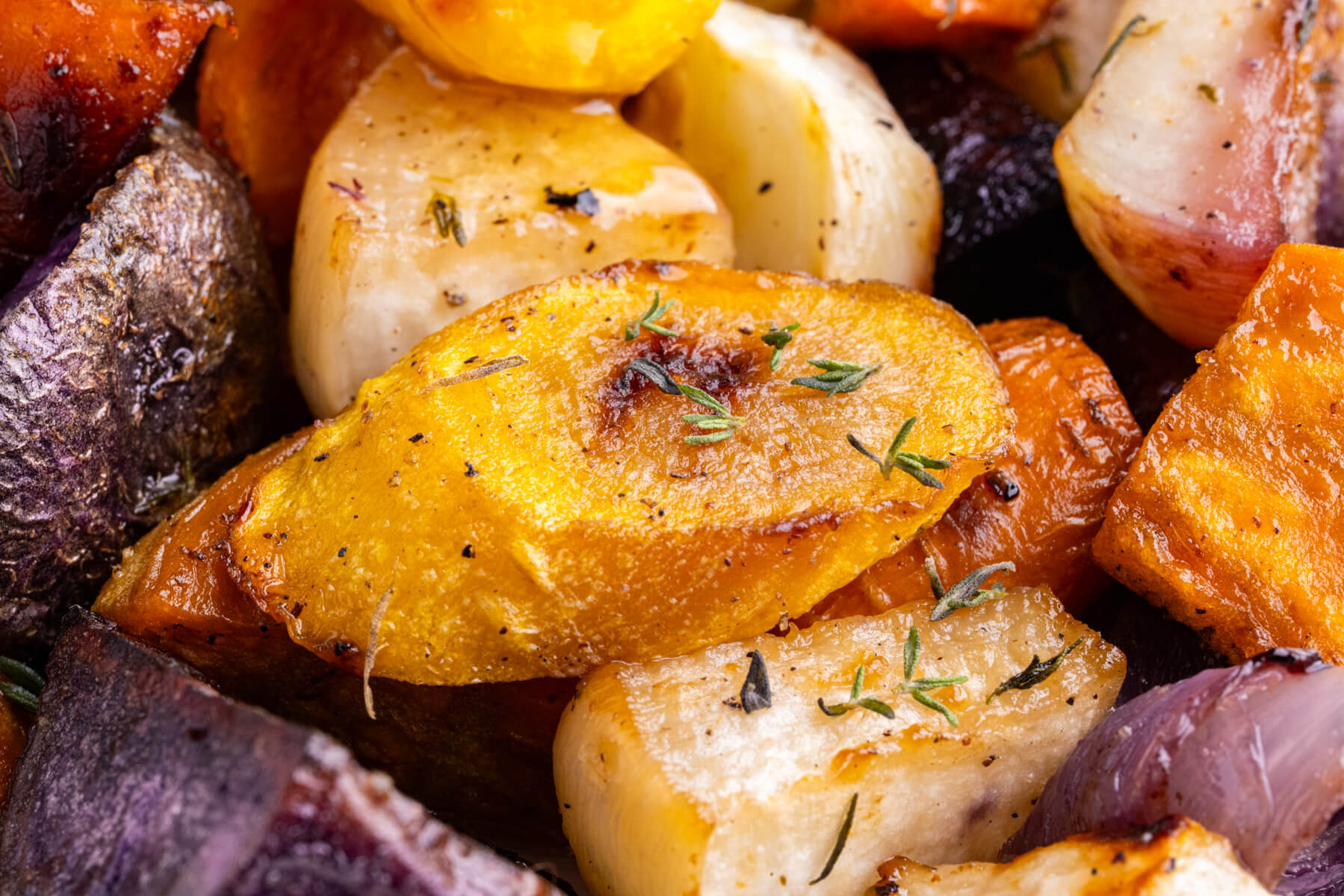 Close up picture of colourful roasted root vegetables.