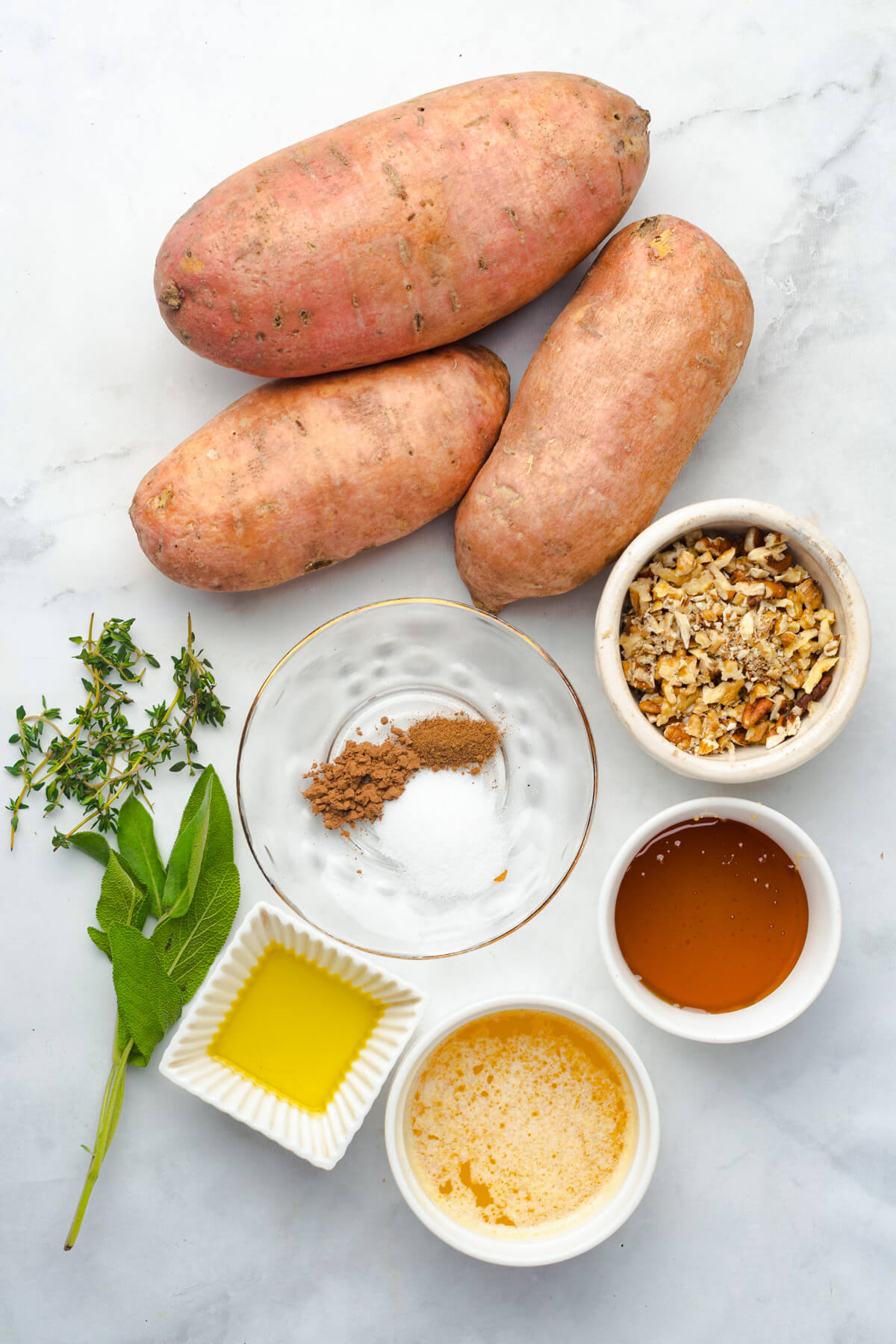 Ingredients required to make hasselback sweet potatoes with a maple butter walnut glaze.
