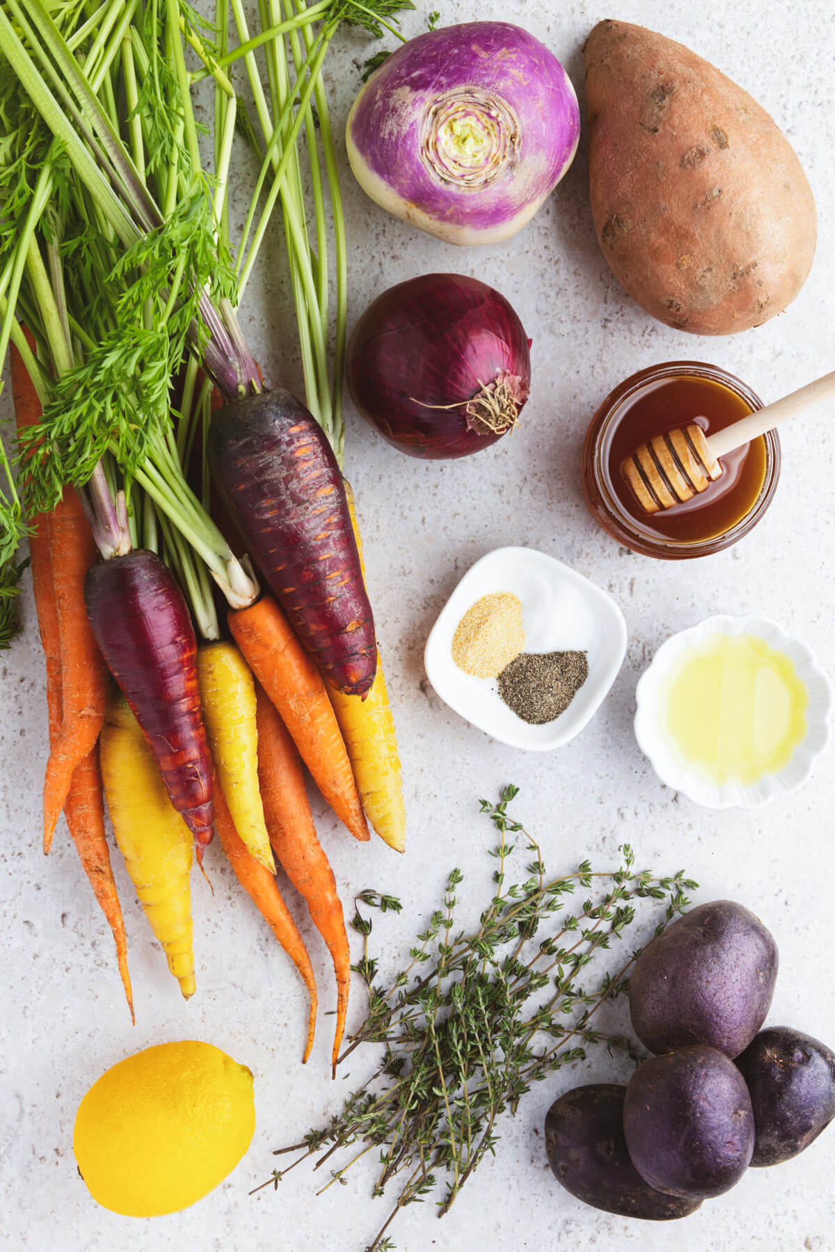 Ingredients required to make roasted root vegetables with honey and thyme.