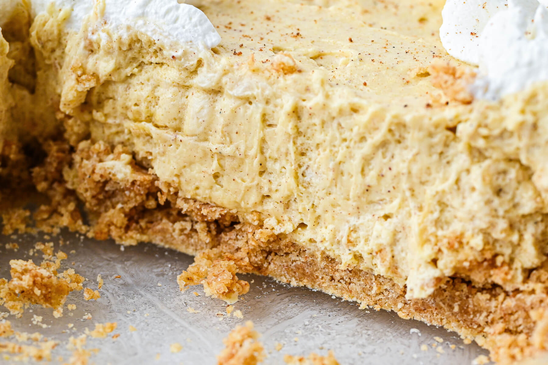 A slice of no bake pie showing the graham cracker pie crust.