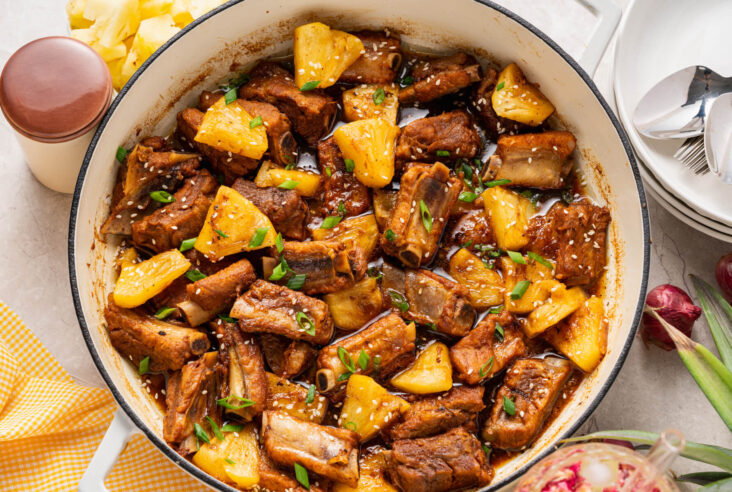 These tender, fall-off-the-bone Sticky Pork Ribs with Pineapple are coated in a sweet-savoury glaze that’s full of rich, umami flavour. A touch of pineapple adds brightness and natural sweetness, balancing the richness of the braised ribs. This easy, flavour-packed dish is perfect served over rice for a comforting and delicious meal the whole family will love.