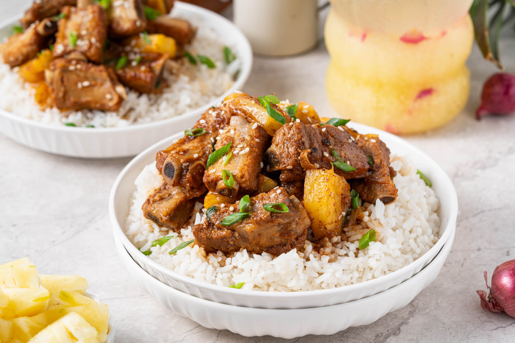 These tender, fall-off-the-bone Sticky Pork Ribs with Pineapple are coated in a sweet-savoury glaze that’s full of rich, umami flavour. A touch of pineapple adds brightness and natural sweetness, balancing the richness of the braised ribs. This easy, flavour-packed dish is perfect served over rice for a comforting and delicious meal the whole family will love.