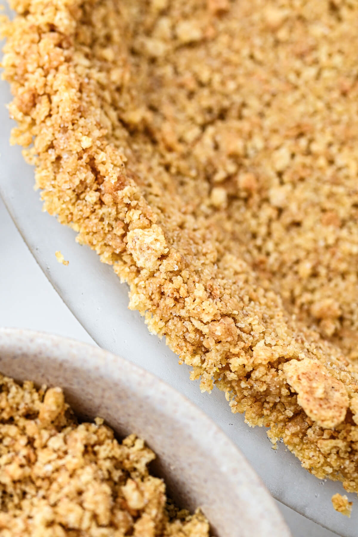 An unfilled 9 inch graham cracker pie crust.