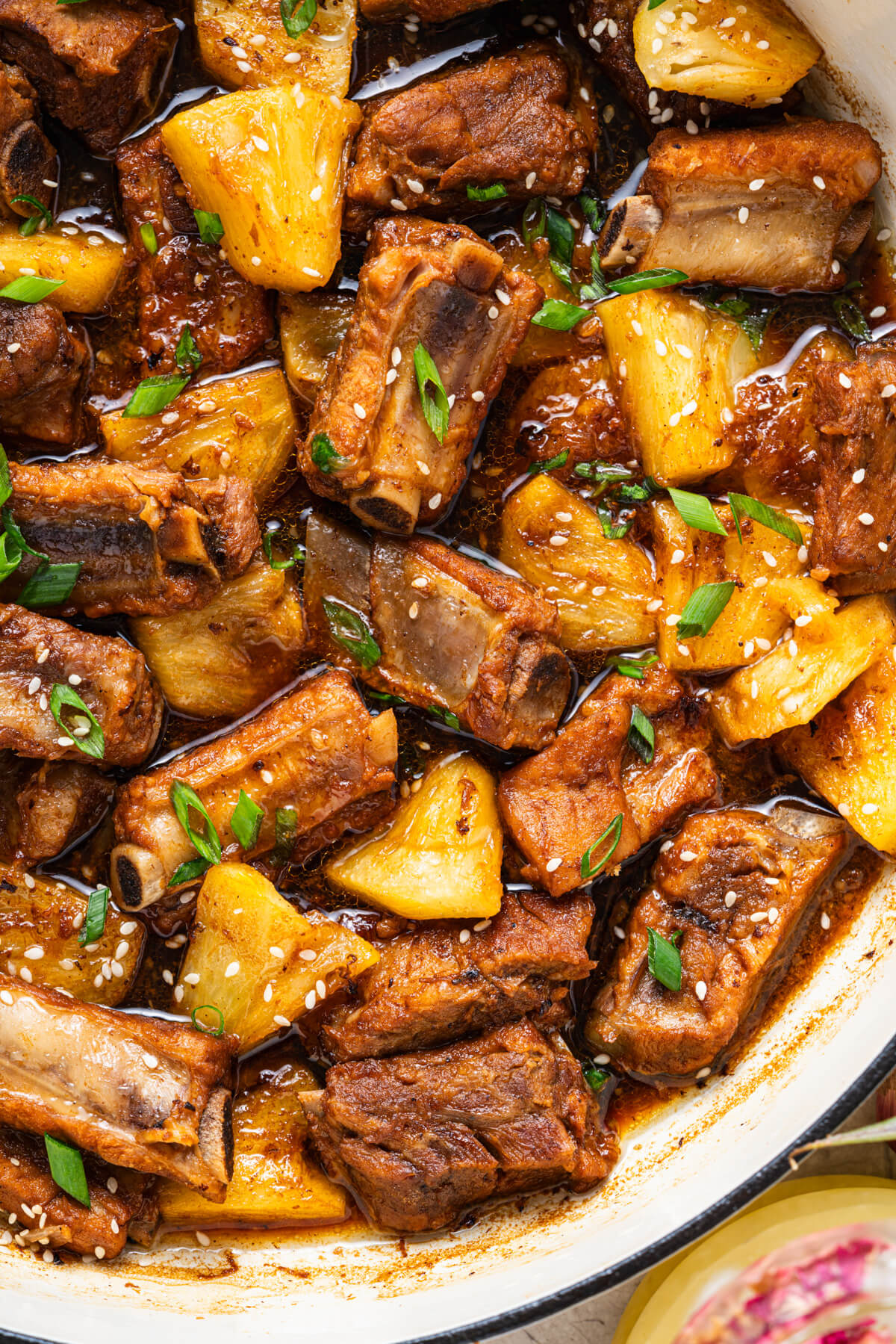 These tender, fall-off-the-bone Sticky Pork Ribs with Pineapple are coated in a sweet-savoury glaze that’s full of rich, umami flavour. A touch of pineapple adds brightness and natural sweetness, balancing the richness of the braised ribs. This easy, flavour-packed dish is perfect served over rice for a comforting and delicious meal the whole family will love.