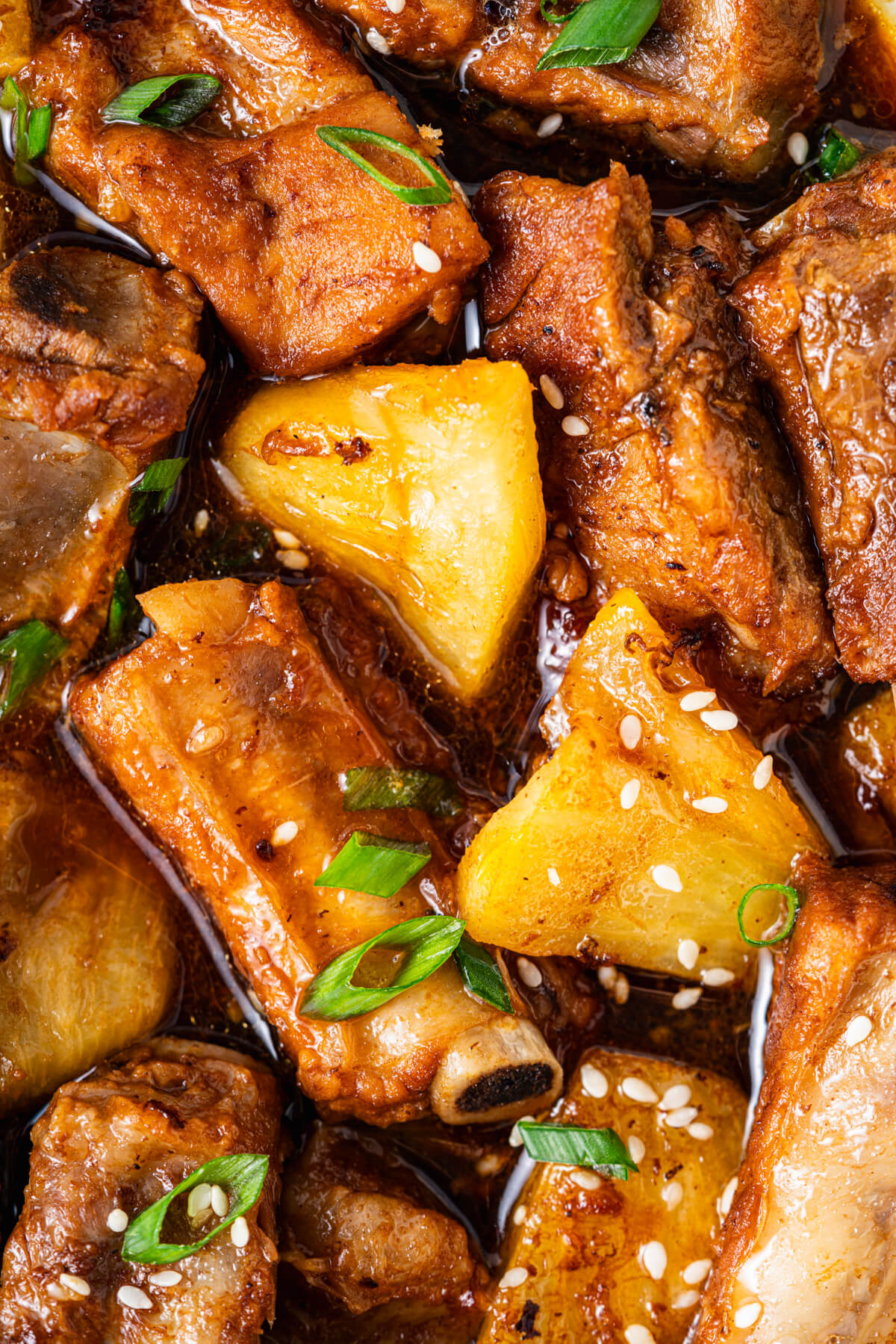 These tender, fall-off-the-bone Sticky Pork Ribs with Pineapple are coated in a sweet-savoury glaze that’s full of rich, umami flavour. A touch of pineapple adds brightness and natural sweetness, balancing the richness of the braised ribs. This easy, flavour-packed dish is perfect served over rice for a comforting and delicious meal the whole family will love.