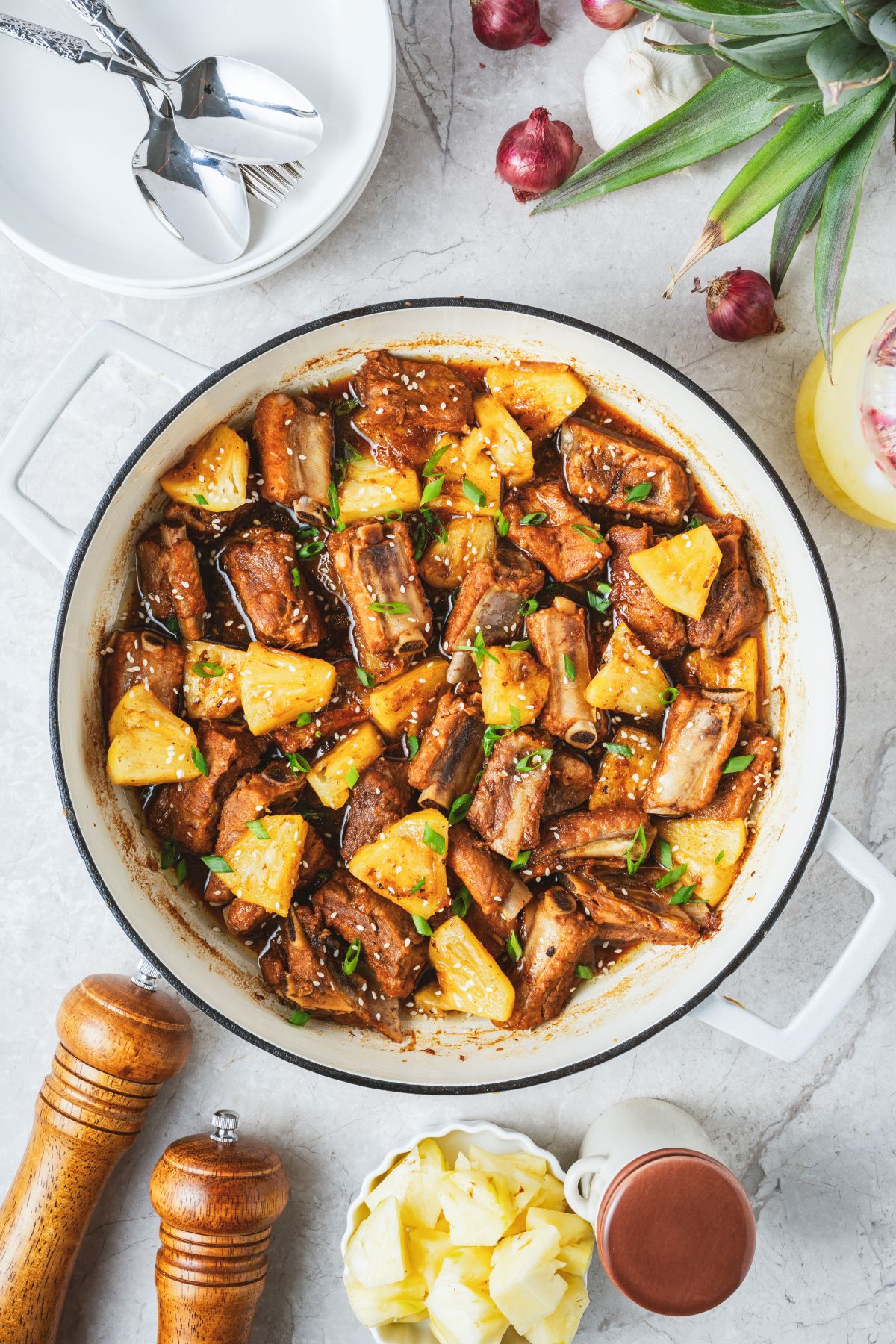 These tender, fall-off-the-bone Sticky Pork Ribs with Pineapple are coated in a sweet-savoury glaze that’s full of rich, umami flavour. A touch of pineapple adds brightness and natural sweetness, balancing the richness of the braised ribs. This easy, flavour-packed dish is perfect served over rice for a comforting and delicious meal the whole family will love.