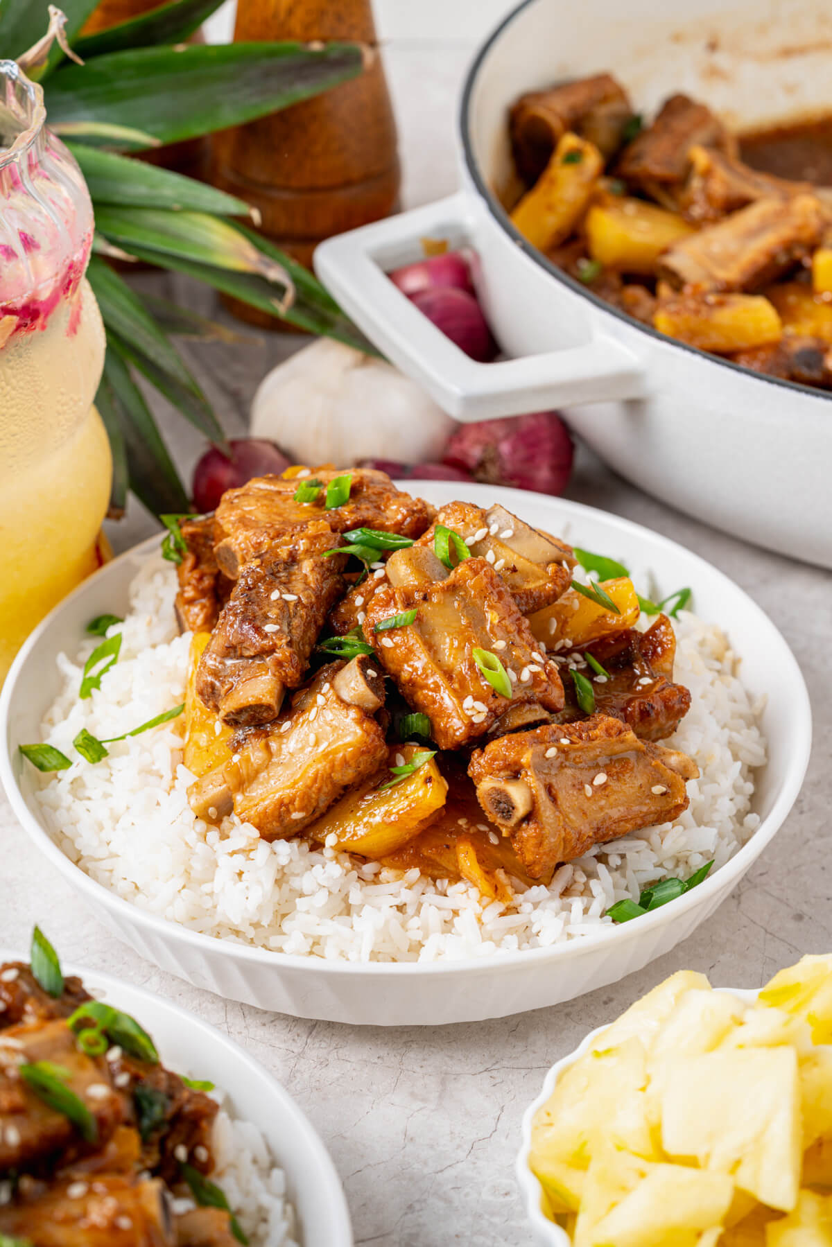 These tender, fall-off-the-bone Sticky Pork Ribs with Pineapple are coated in a sweet-savoury glaze that’s full of rich, umami flavour. A touch of pineapple adds brightness and natural sweetness, balancing the richness of the braised ribs. This easy, flavour-packed dish is perfect served over rice for a comforting and delicious meal the whole family will love.