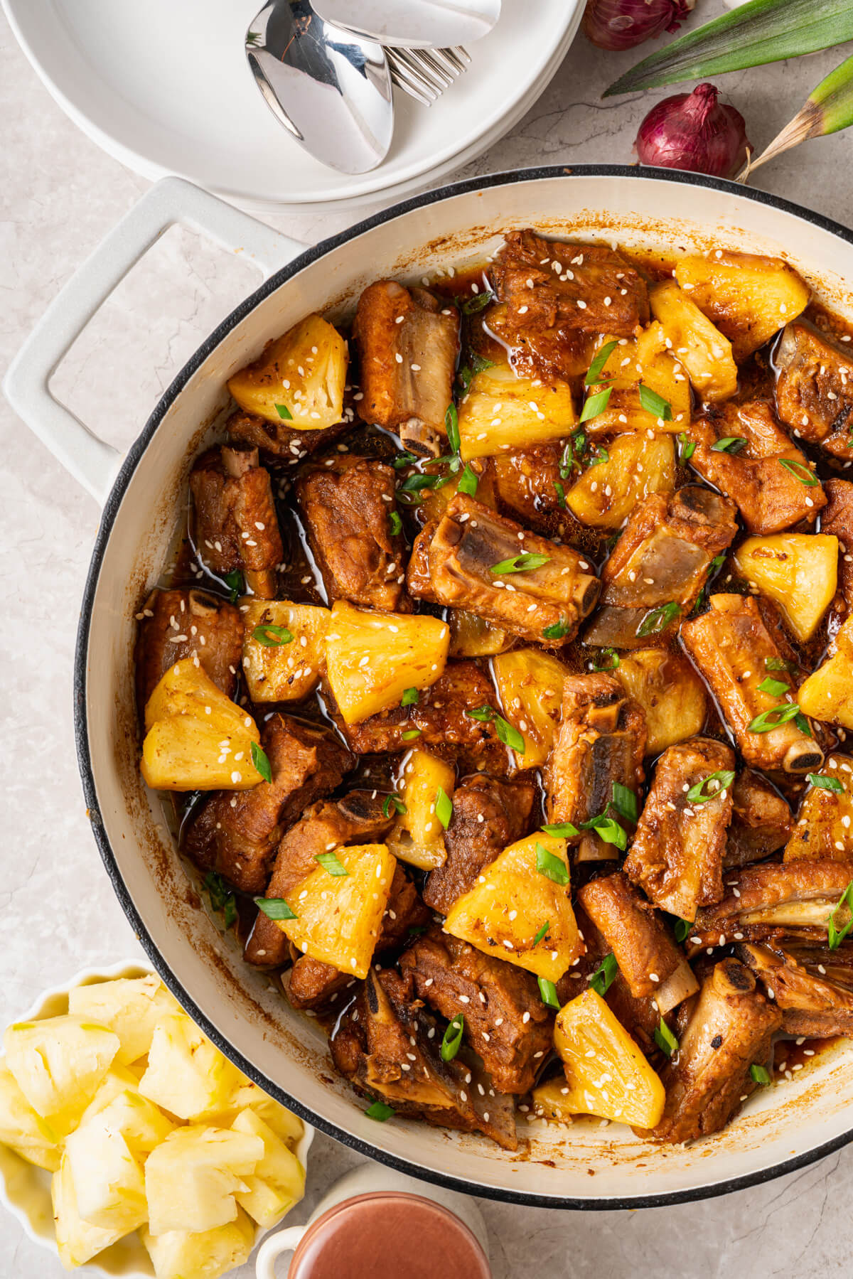 These tender, fall-off-the-bone Sticky Pork Ribs with Pineapple are coated in a sweet-savoury glaze that’s full of rich, umami flavour. A touch of pineapple adds brightness and natural sweetness, balancing the richness of the braised ribs. This easy, flavour-packed dish is perfect served over rice for a comforting and delicious meal the whole family will love.