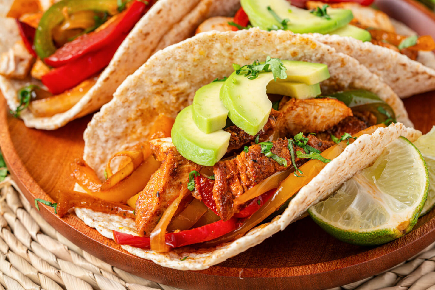 One chicken fajita stuffed with juicy chicken, sauteed peppers, onions, and topped with sliced avocado and chopped cilantro.