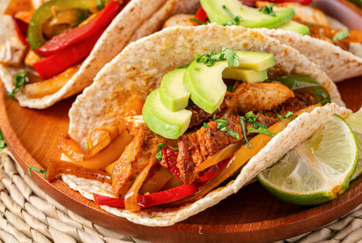 One chicken fajita stuffed with juicy chicken, sauteed peppers, onions, and topped with sliced avocado and chopped cilantro.