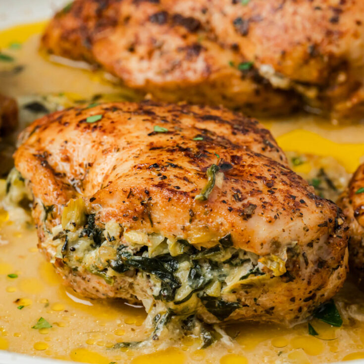 A golden seared chicken breast stuffed with creamy spinach and artichoke stuffing.