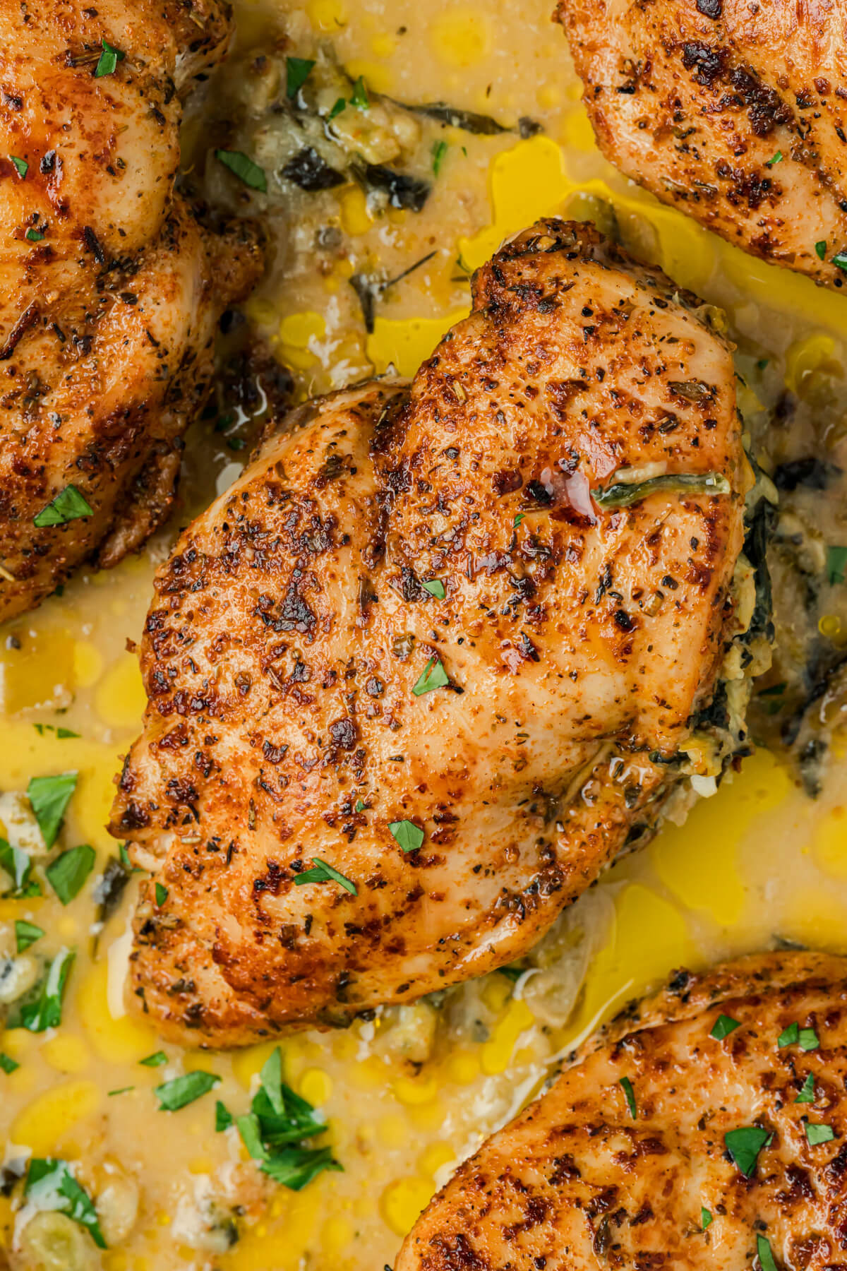 Golden seared chicken breast stuffed with creamy spinach and artichoke stuffing.