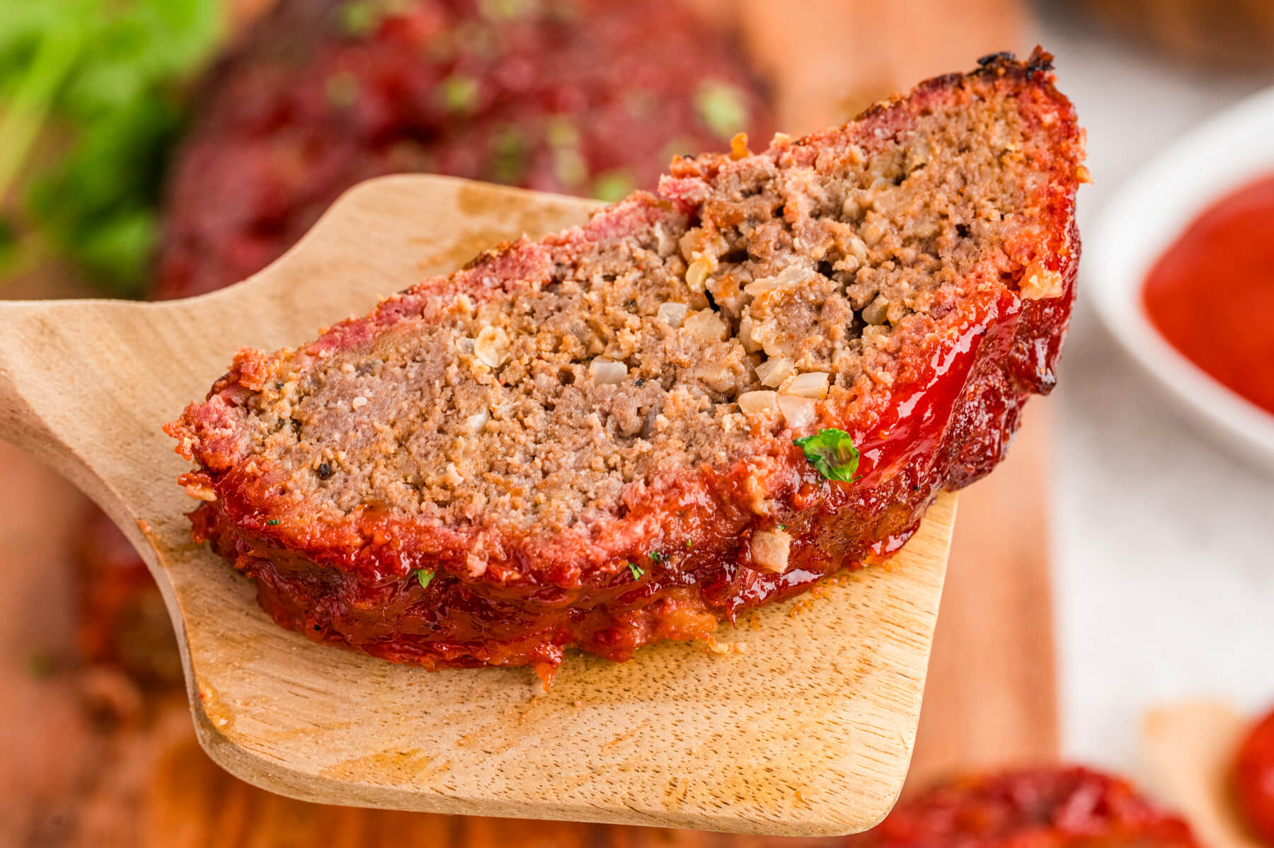 One slice of smoked meatloaf showing the outer smoke ring or bark. 