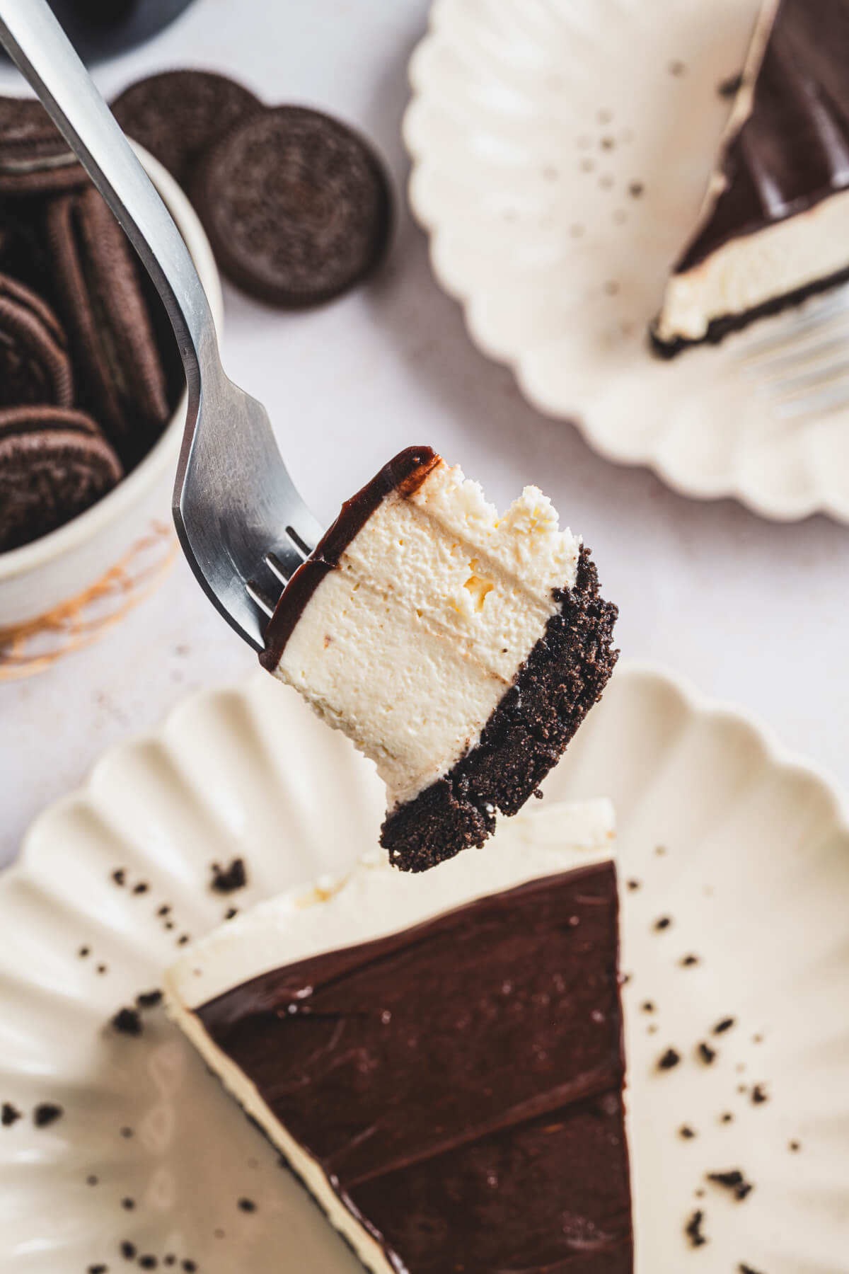 A forkful of Bailey's Cheesecake floating above a piece of cheesecake.