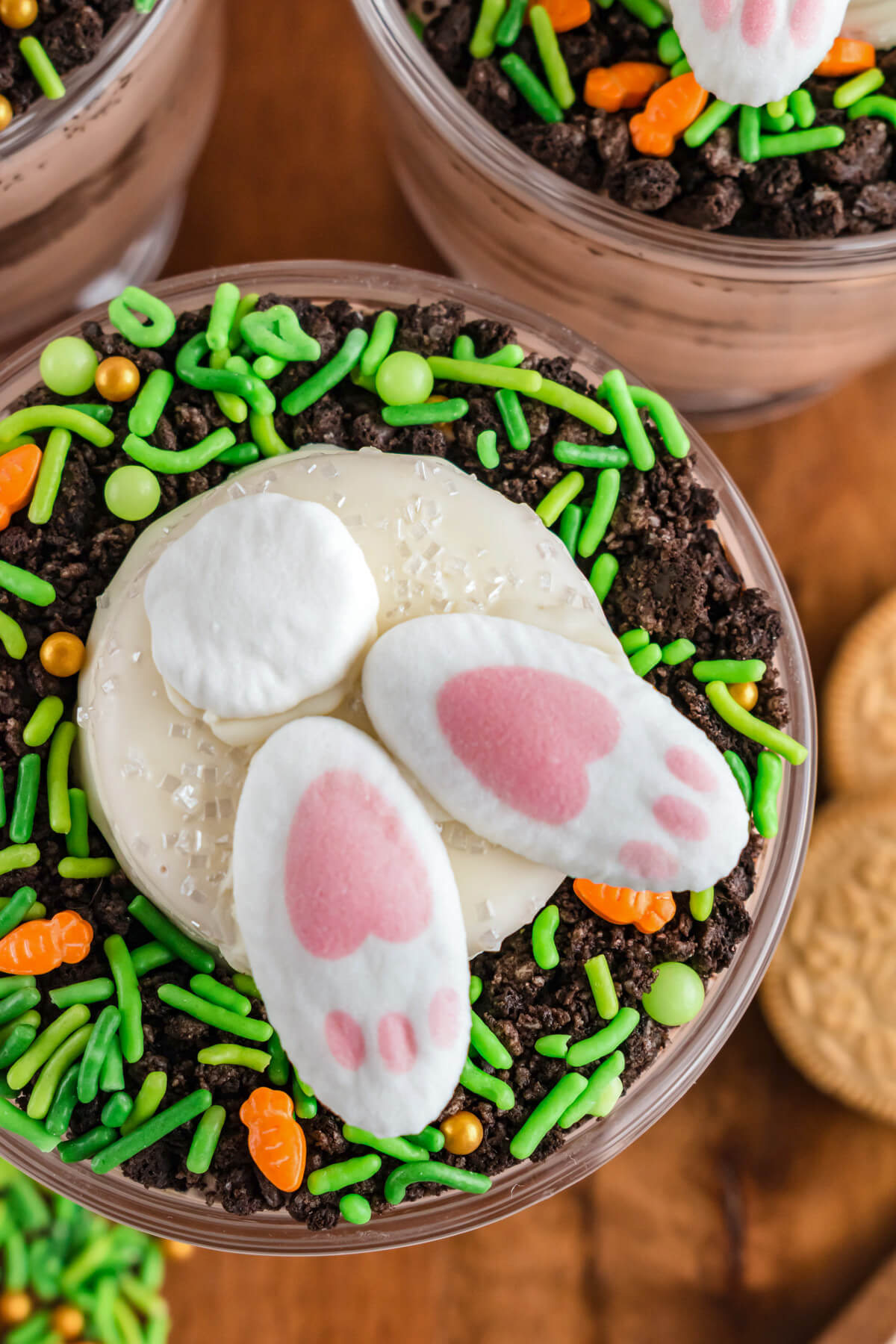 Close up photo showing the top of an Easter trifle topped with a bunny butt cookie.