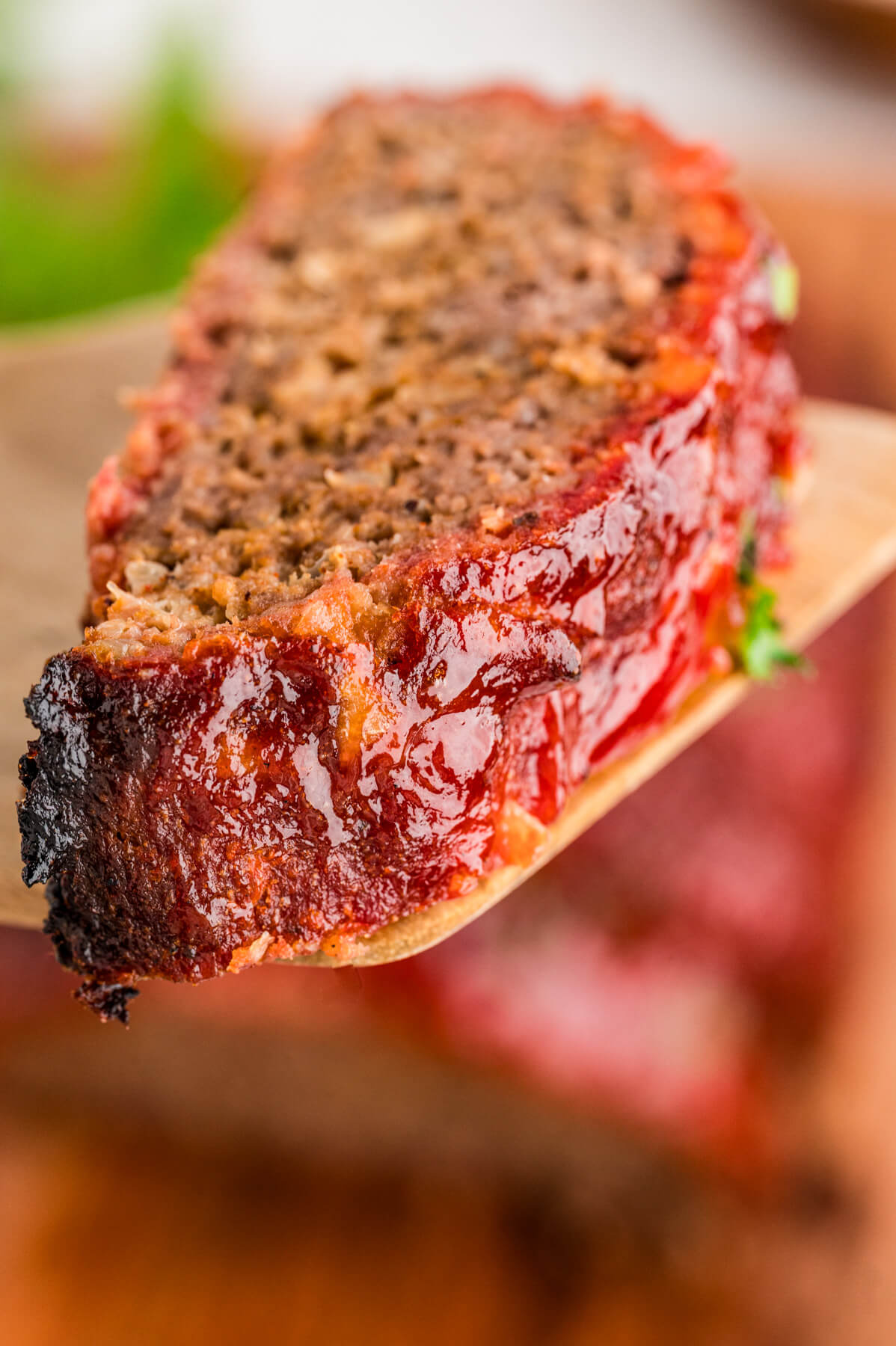 One slice of smoked meatloaf showing the outer smoke ring or bark.