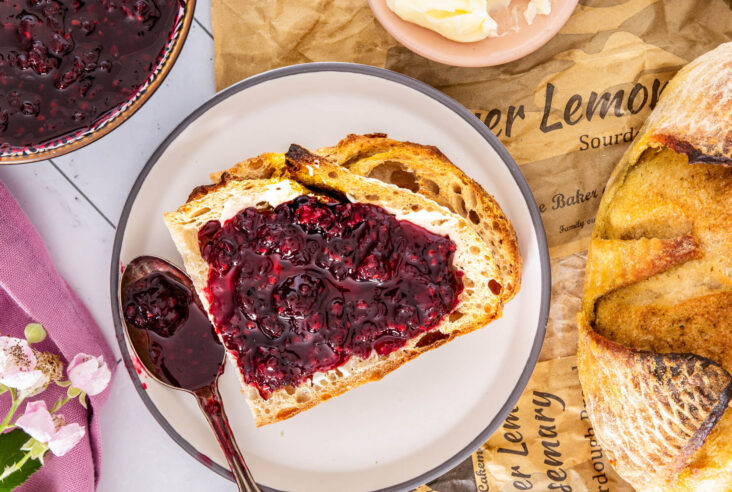 Slices of sourdough bread topped with glistening homemade blackberry jam.
