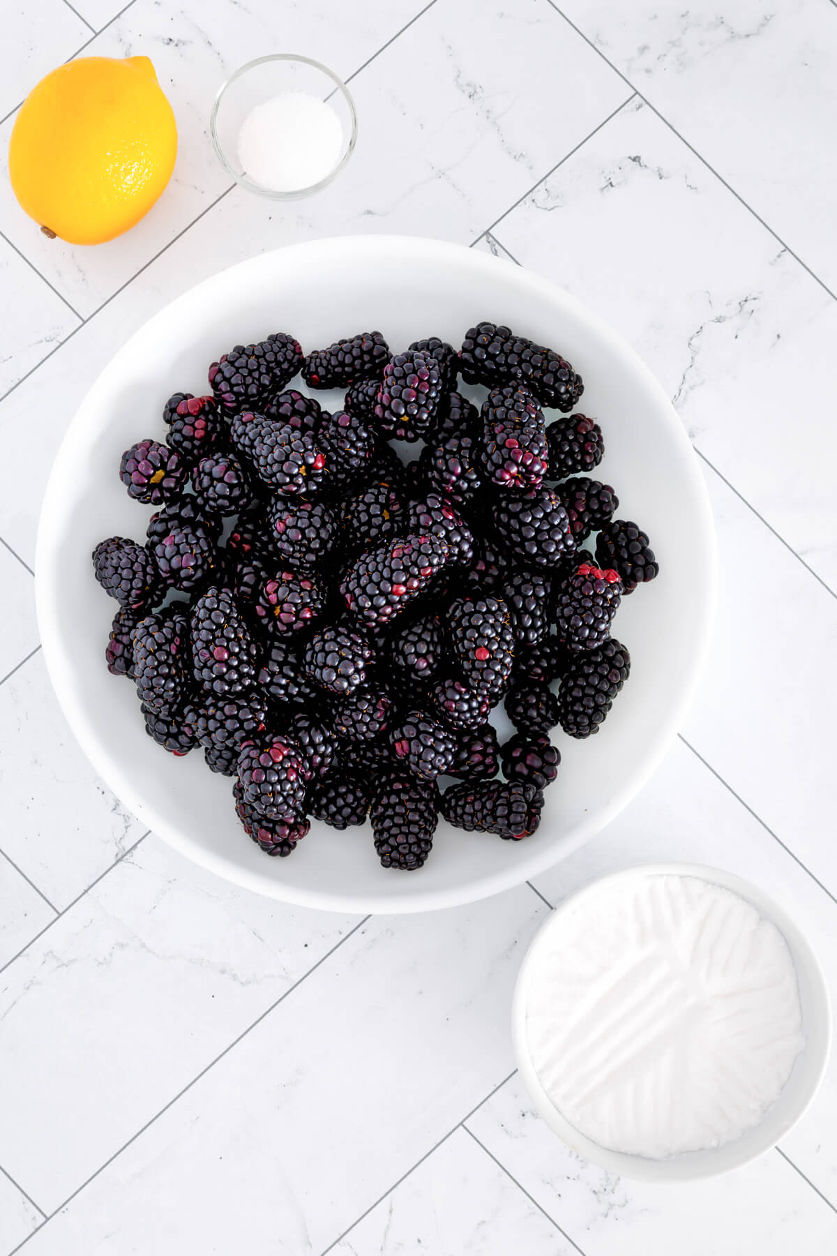 Ingredients required to make homemade blackberry jam.