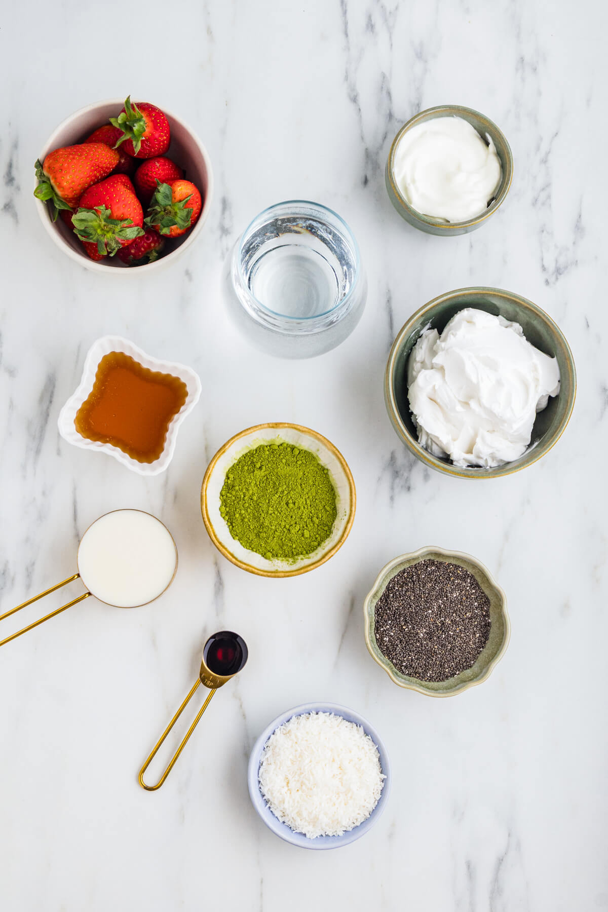 Ingredients required to make and top a jar of Coconut Matcha Chia Pudding.
