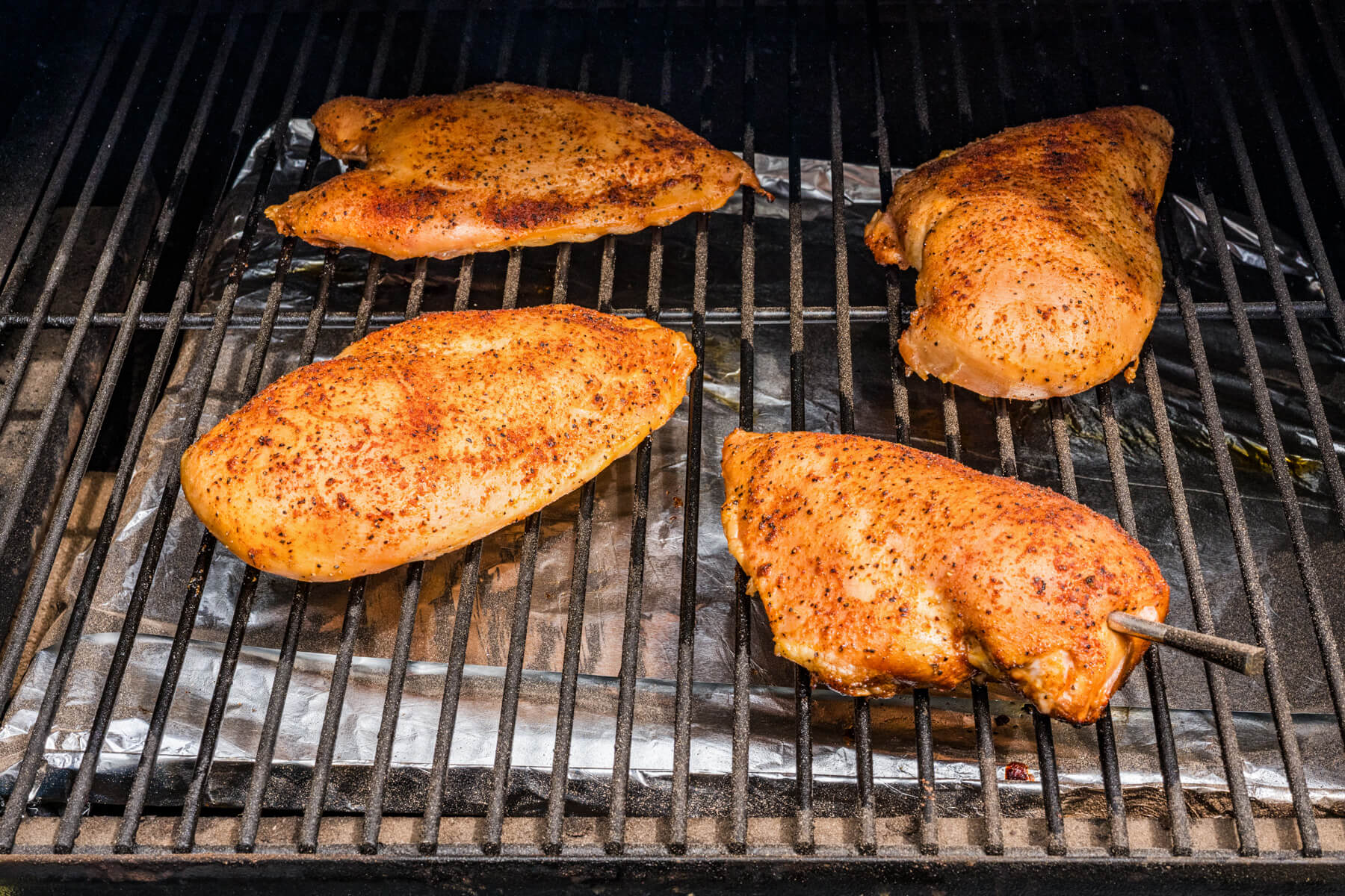 Chicken breasts on a smoker grill. 