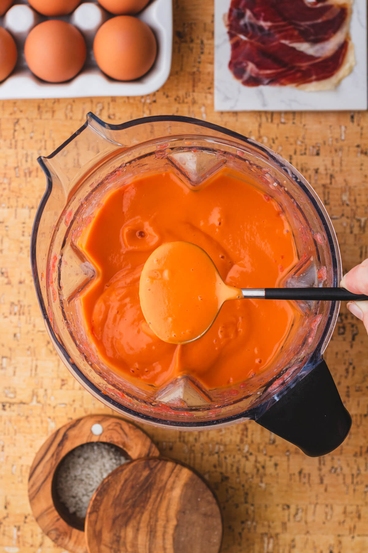 Fully smooth vibrant orange Salmorejo in a Vitamix blender.