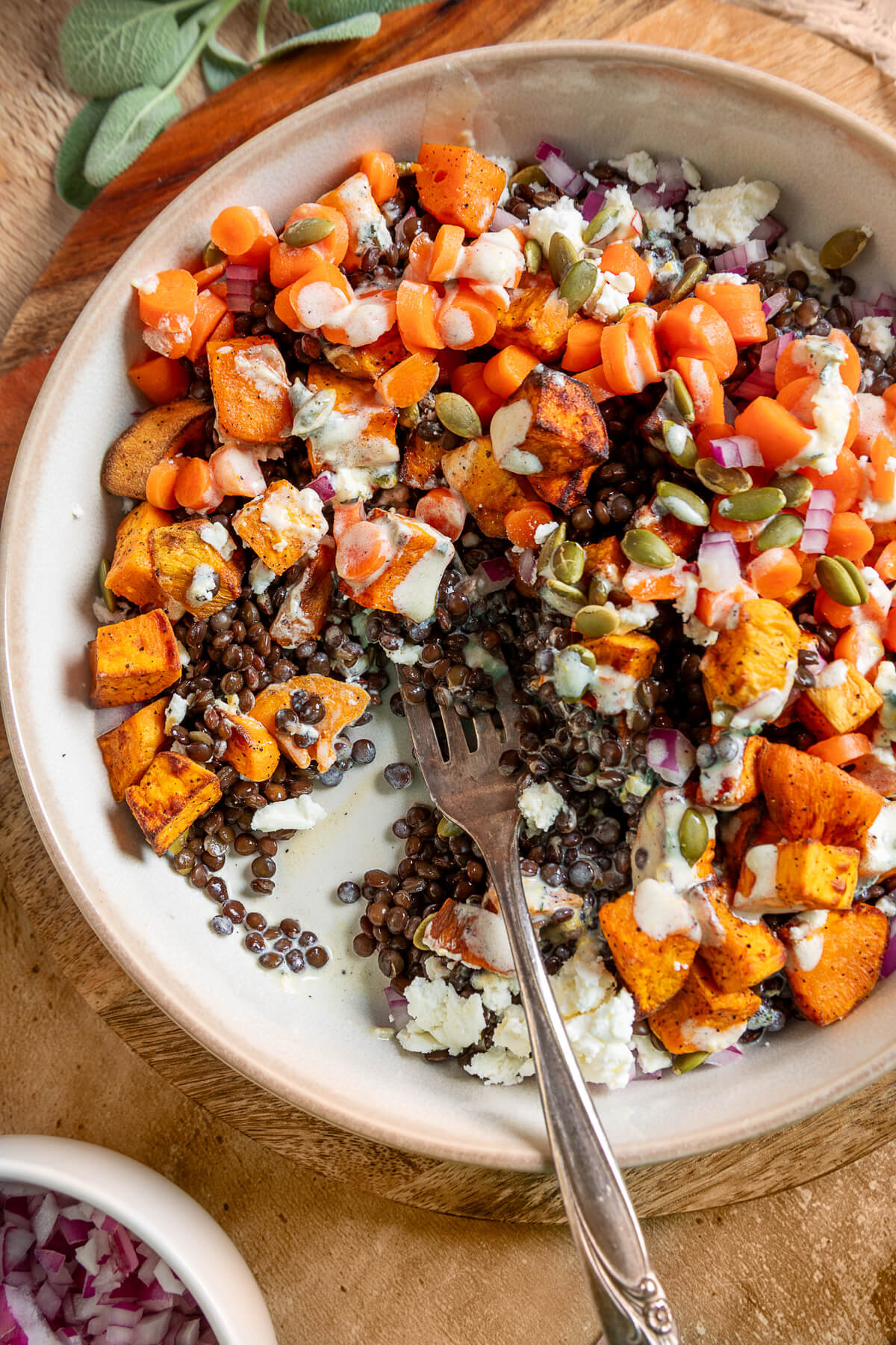 Close up of Sweet Potato Lentil Bowl with bites missing and a fork digging in.